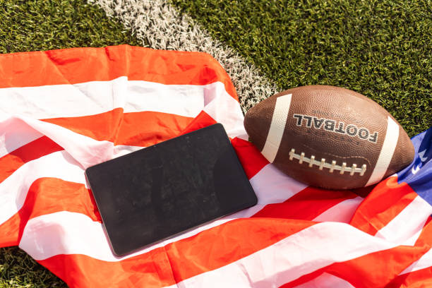 american football ball and tablet, american flag american football ball and tablet, american flag. american football free bet no deposit stock pictures, royalty-free photos & images