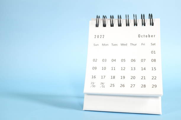 istock Selective focus of October 2022 desk calendar on blue background with copy space. 1424214918