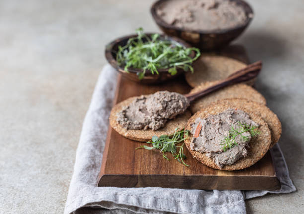 domowy pasztet z mięsa lub wątróbki drobiowej z wieloziarnistymi krakersami i mikrozielonym, jasnym tłem. - foie gras goose meat liver pate zdjęcia i obrazy z banku zdjęć