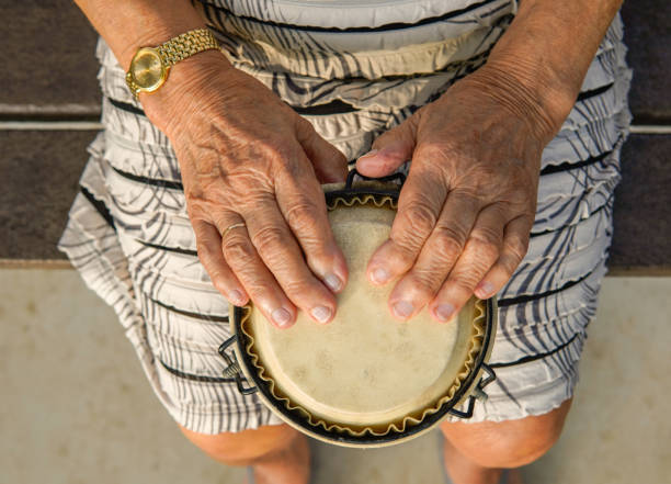 istock Lady playing an african drum. Percussion workshop and music therapy. Aerial view 1424220484