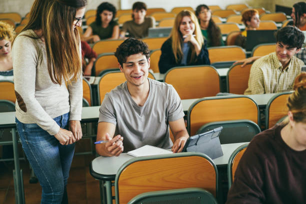 istock Mature teacher working with students inside classroom at school university 1424221723