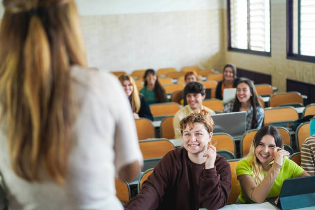 istock Mature teacher working with students inside classroom at school university 1424221725