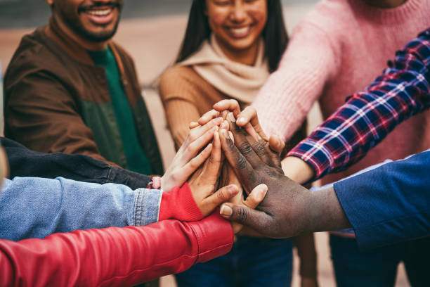 istock Young group of people stacking hands outdoor 1424222539