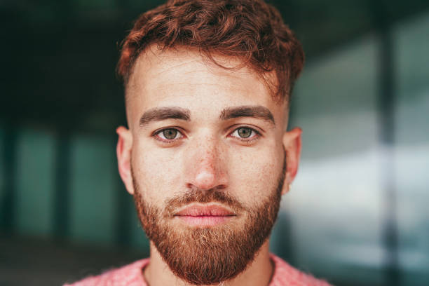Young happy man looking on camera outdoor