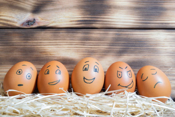 istock Brown easter eggs with funny faces on a wooden background 1424224857