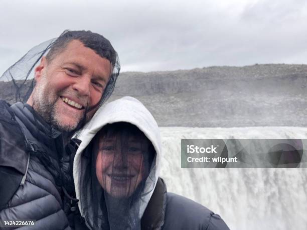 Father And Son Happy Selfie Wearing Head Nets Protection Against Midges Chironomids At Powerful Waterfall Stock Photo - Download Image Now