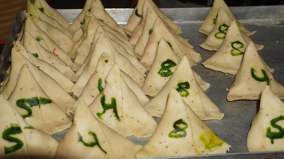 Raw samosas are ready to be served in a plate