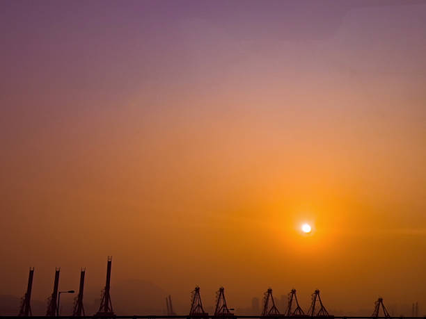Silhouette of Shipping doc cranes during sunrise