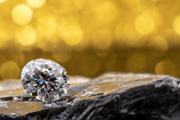 istock Diamond on Natural Stone With Golden Yellow Bokeh Background 1424230100