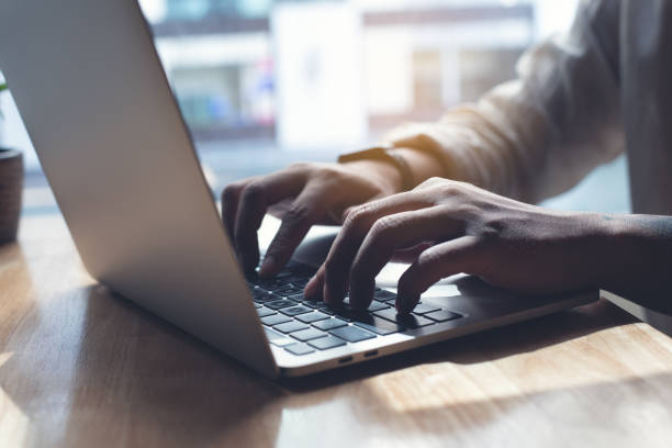 istock Business man working on laptop computer, typing on laptop keyboard on office table, surfing the internet, online job, online study, e-learning, working at home, telecommuting concept 1424230706