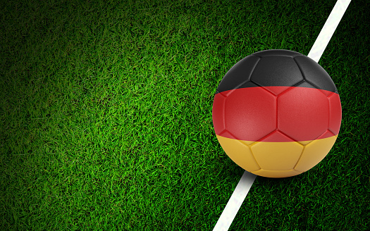 German flag on a soccer ball over soccer field. Easy to crop for all your social media and design need.