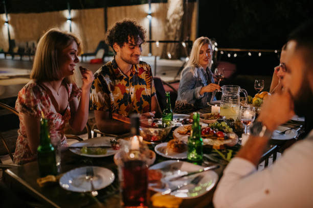 istock A group of cheerful friends are having a crazy time during dinner 1424234525