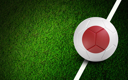 Japanese flag on a soccer ball over soccer field. Easy to crop for all your social media and design need.