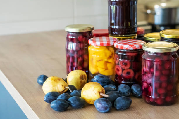 Preserving organic fruit in jars  for winter. stock photo