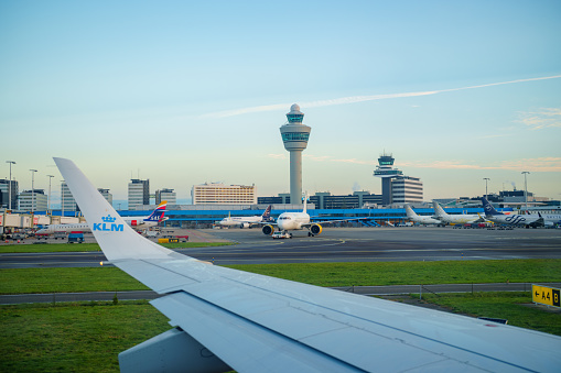 Schiphol , Amsterdam - September 7, 2022: View of Amsterdam Airport Schiphol tower as seen from airplane taxiing on runway
