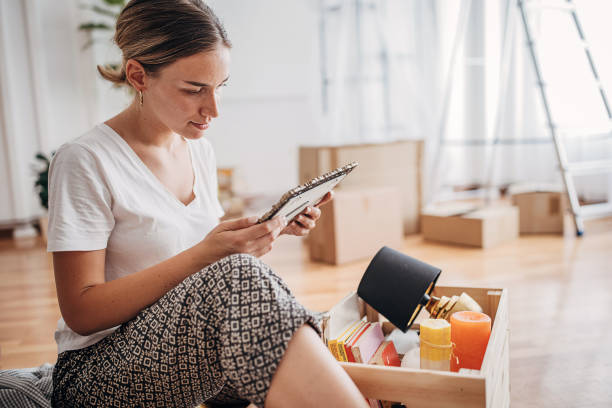 istock Woman unpacking in new home 1424241682