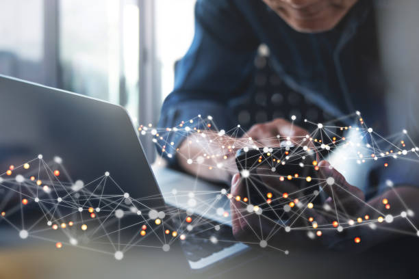 istock Internet network connection, digital technology background, IoT Internet of Things concept. Man using computer laptop and mobile smart phone with line and dot connection 1424245189