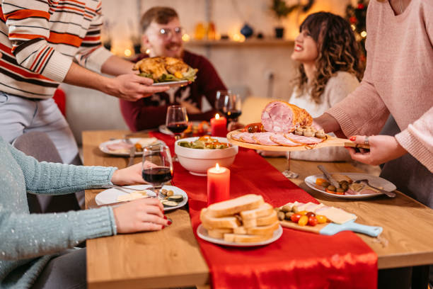 istock Group Of Friends Setting Up The Table For New Year's Eve Dinner 1424245219