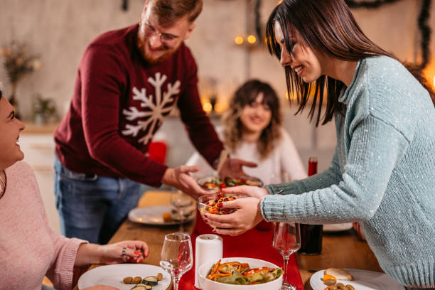 istock Group Of Friends Setting Up The Table For New Year's Eve Dinner 1424245264