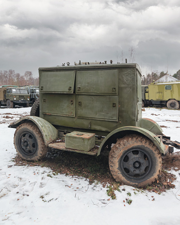 Mobile army diesel power generator abandoned along with military equipment in the snow