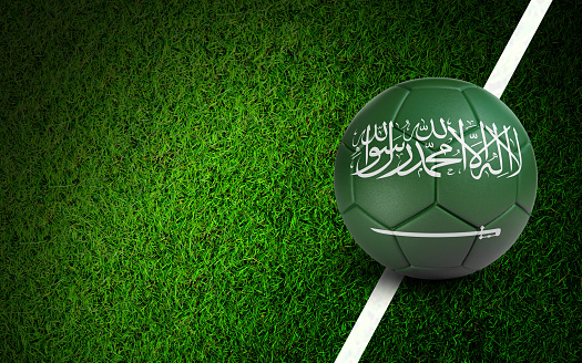 Saudi Arabian flag on a soccer ball over soccer field. Easy to crop for all your social media and design need.