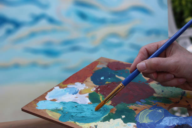 Artist painter working with paint palette on art painting