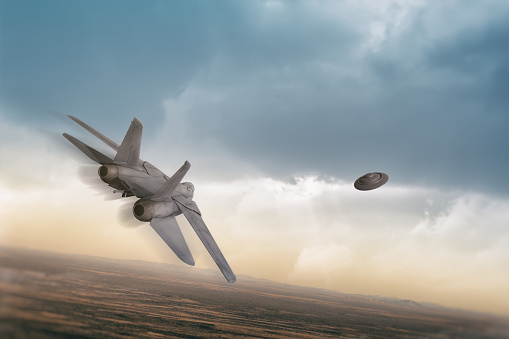 An American fighter jet pursues a UFO over an arid desert area.