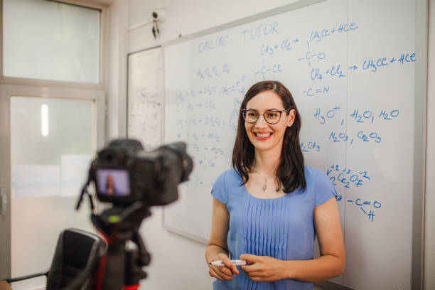istock Smiling female teacher teaching chemistry for an online class 1424251647