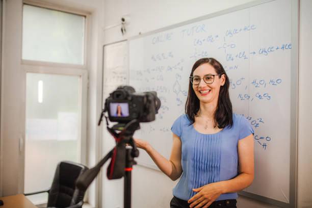 istock Smiling female teacher teaching chemistry for an online class 1424251741
