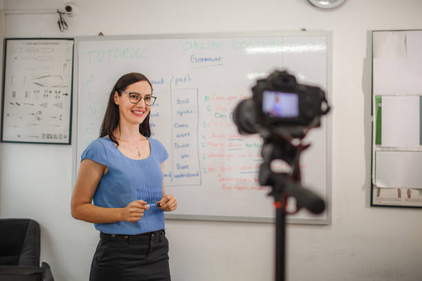 istock Smiling female teacher teaching chemistry for an online class 1424251831