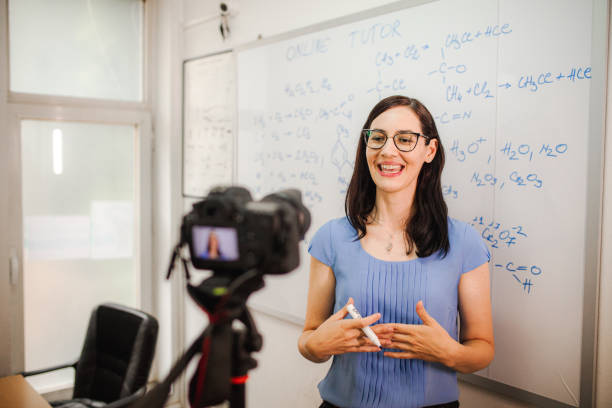 istock Smiling female teacher teaching chemistry for an online class 1424251876