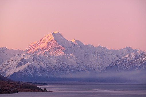 The sunset on a clear day over Aoraki Mount Cook ranges through blue, orange and ends in shades of pink.  This image was achieved with a 20 second exposure in early Spring.
