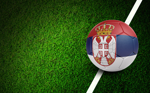 Serbian flag on a soccer ball over soccer field. Easy to crop for all your social media and design need.