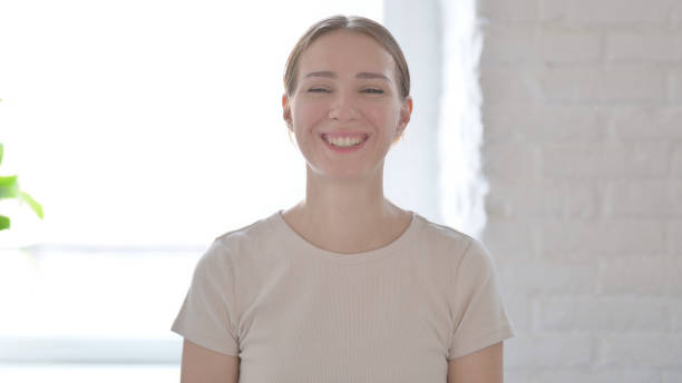 istock Portrait of Woman Smiling at Camera 1424255416