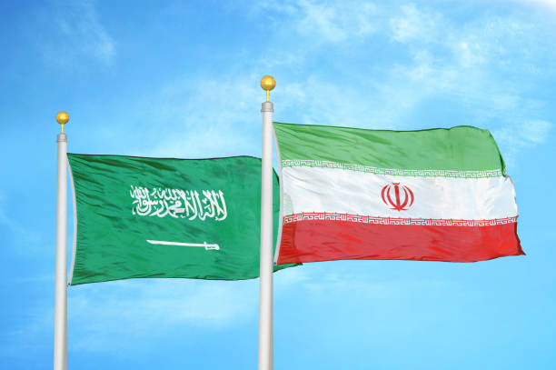 istock Iran and Saudi Arabia two flags on flagpoles blue sky 1424255768