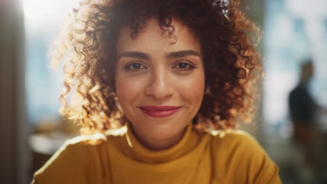 Close Up Portrait of a Beautiful Multiethnic Arab Woman with Brown Eyes and Curly Hair. Cheerful Young Female with a Big Smile Enjoying Life, Success and Empowerment.