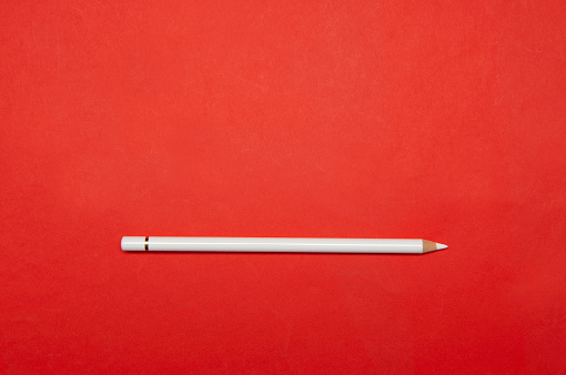 White pencil on red.White pencil on red.