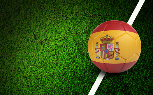 Spanish flag on a soccer ball over soccer field. Easy to crop for all your social media and design need.