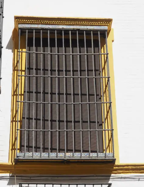 Photo of Typical old Andalusian large window with metal bars