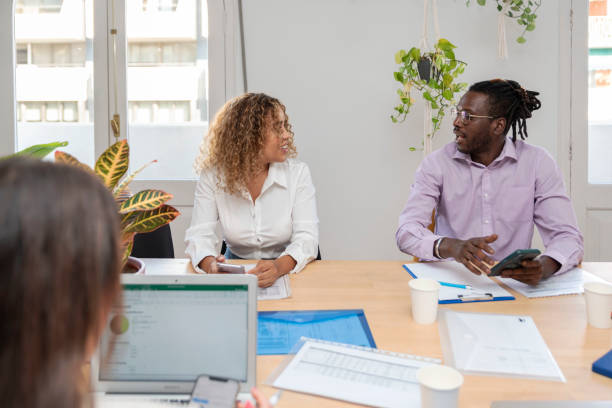 istock two multiracial coworkers talking in the office 1424262608