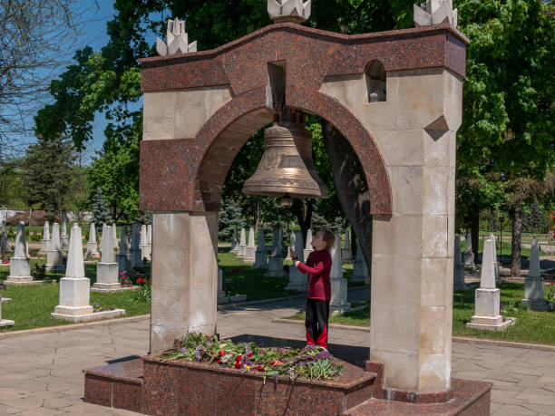 A large bronze bell in a military cemetery. Memorial Complex.