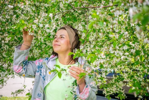 istock brunette woman with blooming cherry tree 1424264802
