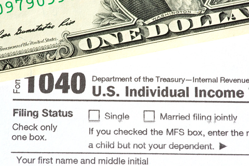 Dollar Bill and Form 1040 Tax Return