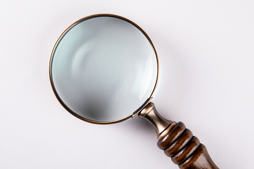 Magnifying glass on a white background. Search and research concept.