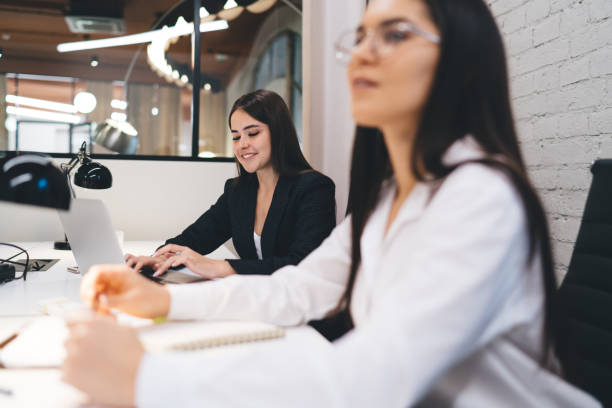 istock Cheerful woman working in creative workplace 1424267225