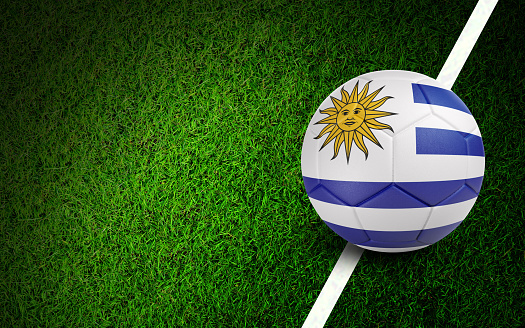 Uruguaian flag on a soccer ball over soccer field. Easy to crop for all your social media and design need.