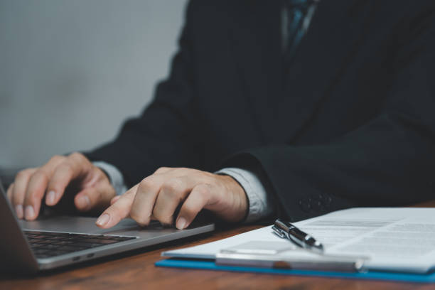 istock Businessman hand work on keyboard laptop computer at office table close up.business and technology concept. 1424267862