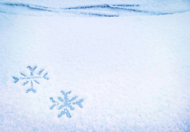 istock Two snowflakes hand drawing (painted) on snow under windshield wiper of car. 1424269364