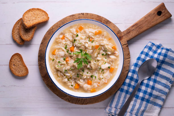 Soupy rice with artichokes and carrots. Typical Spanish gastronomy platter.