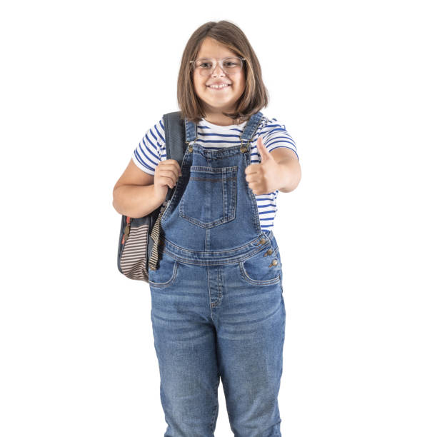 istock School attending girl wears backpack and shows thumb up expression on an isolated white background. 1424269944